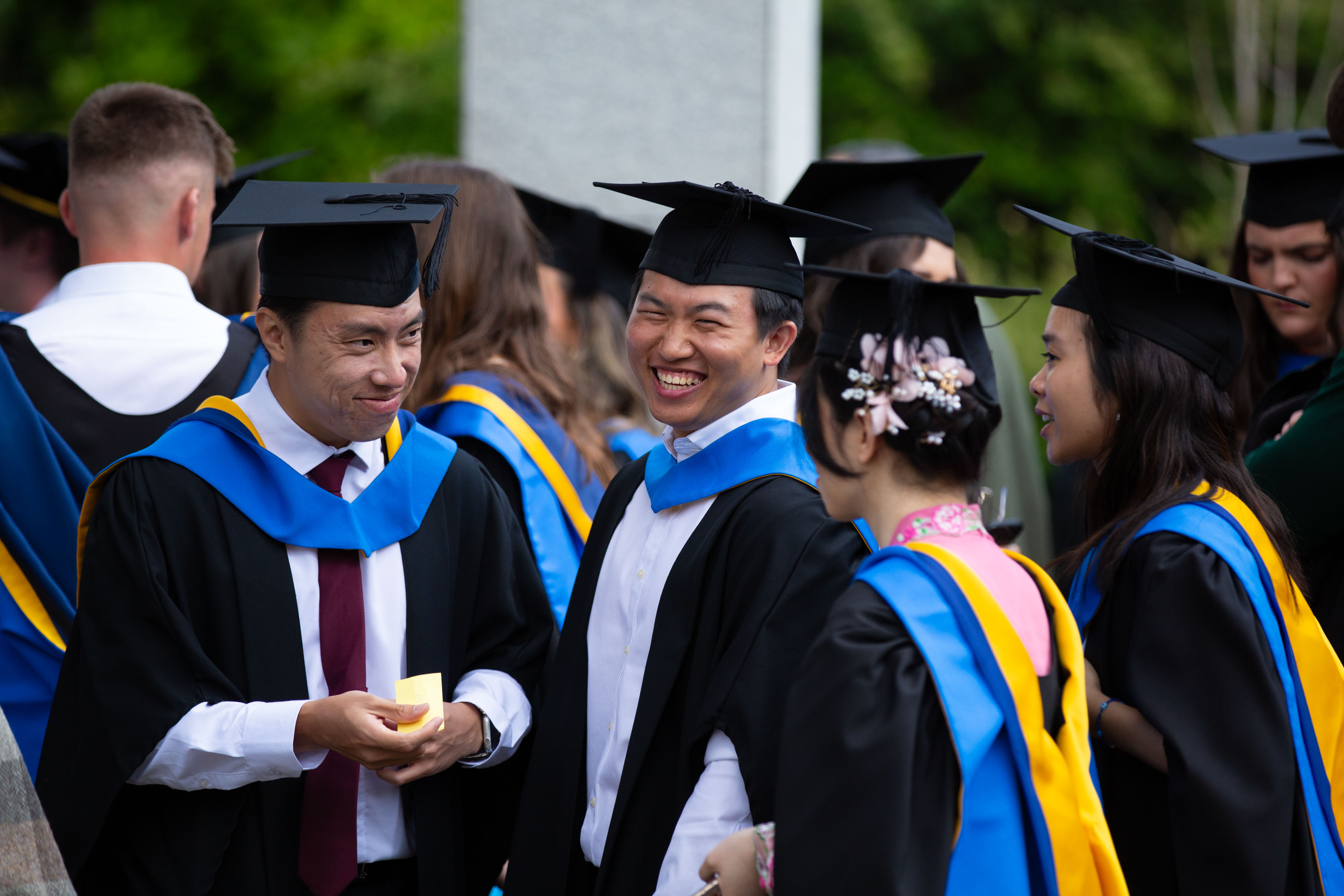 Three students smiling